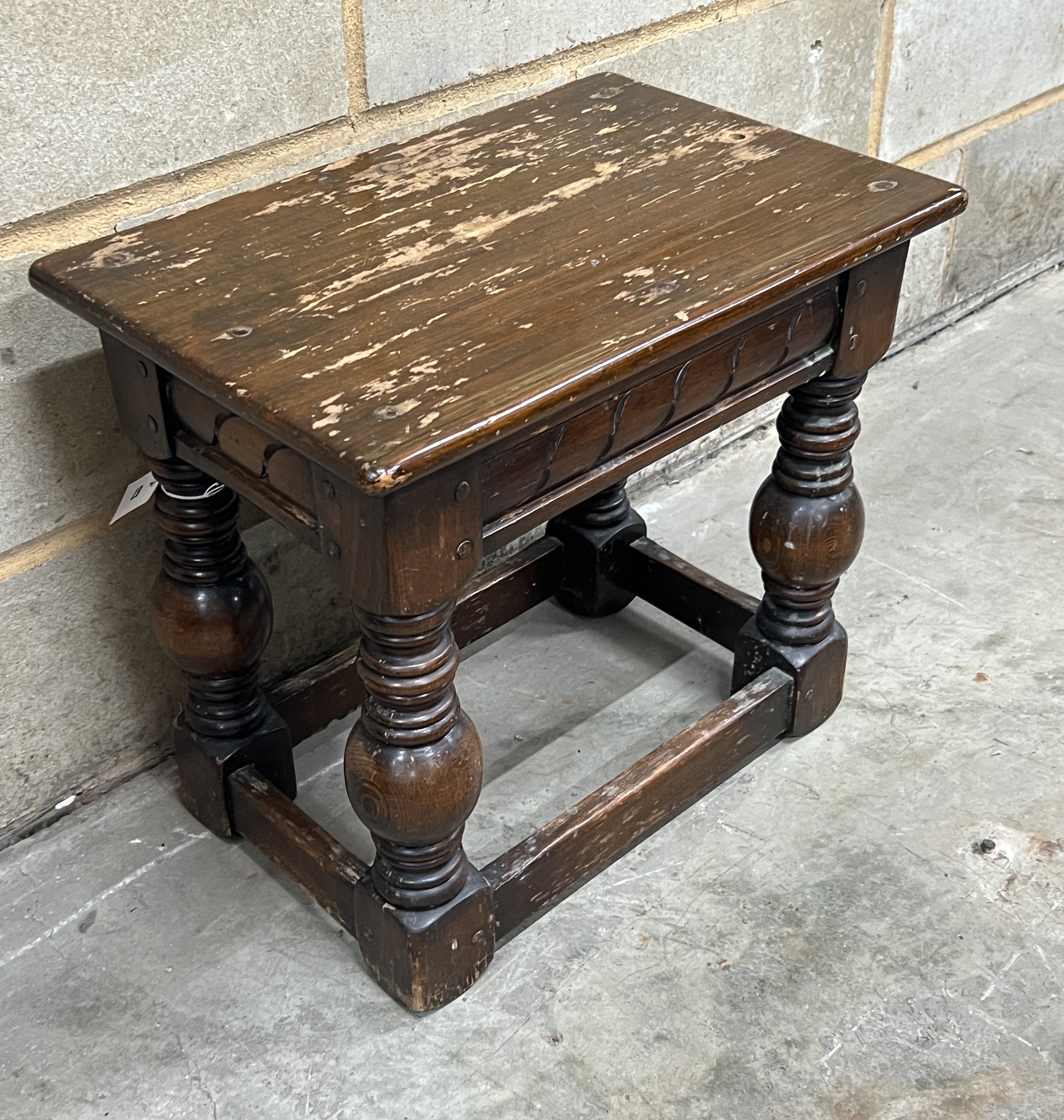 A rectangular 17th century style joint stool, width 53cm, height 48cm together with a pair of carved table bases